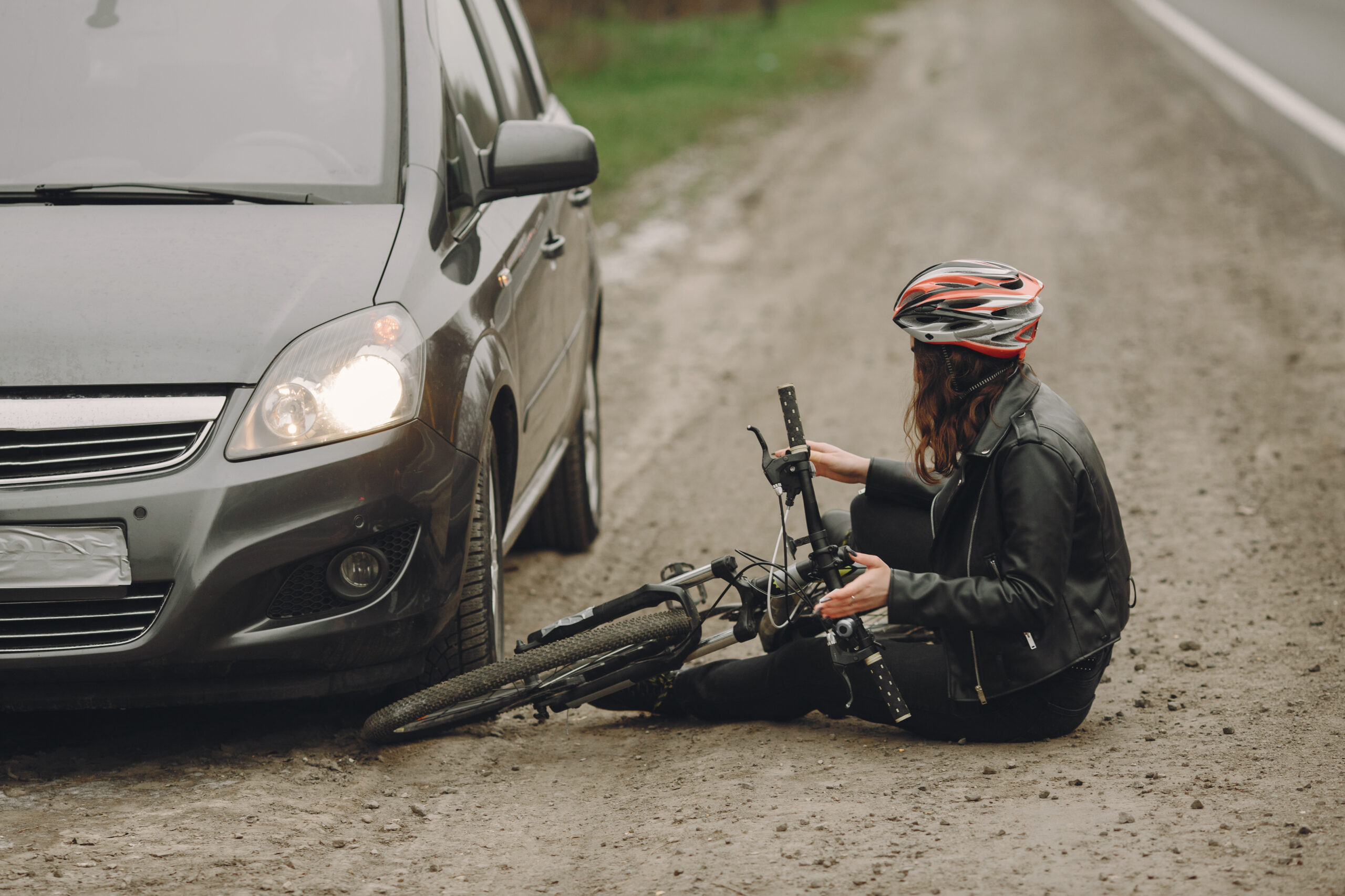 Road accident with cyclist woman driver and car Bicycle Accidents and Injuries