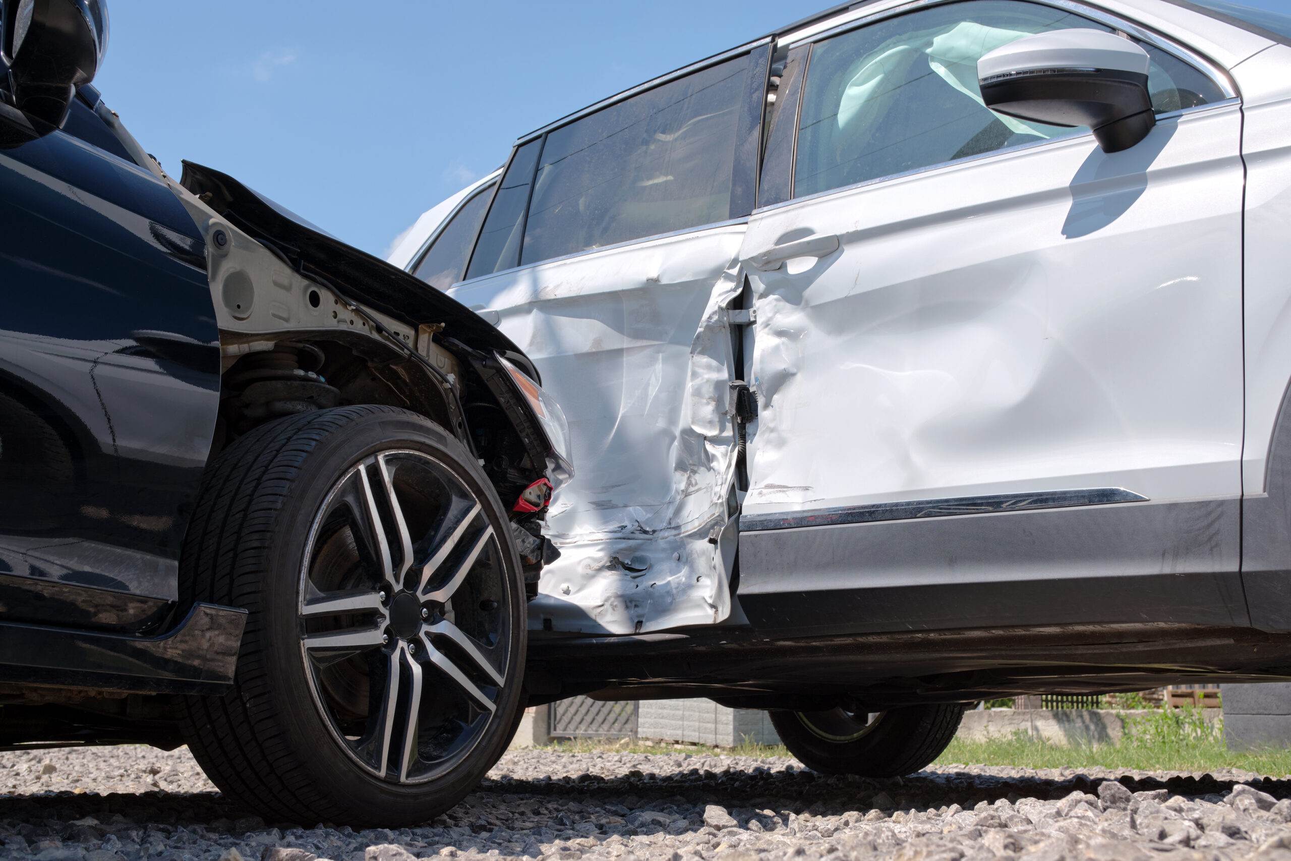 Damaged in heavy car accident vehicles after collision on city street crash site. Road safety and insurance concept Damaged in heavy car accident vehicles after collision on city street crash site
