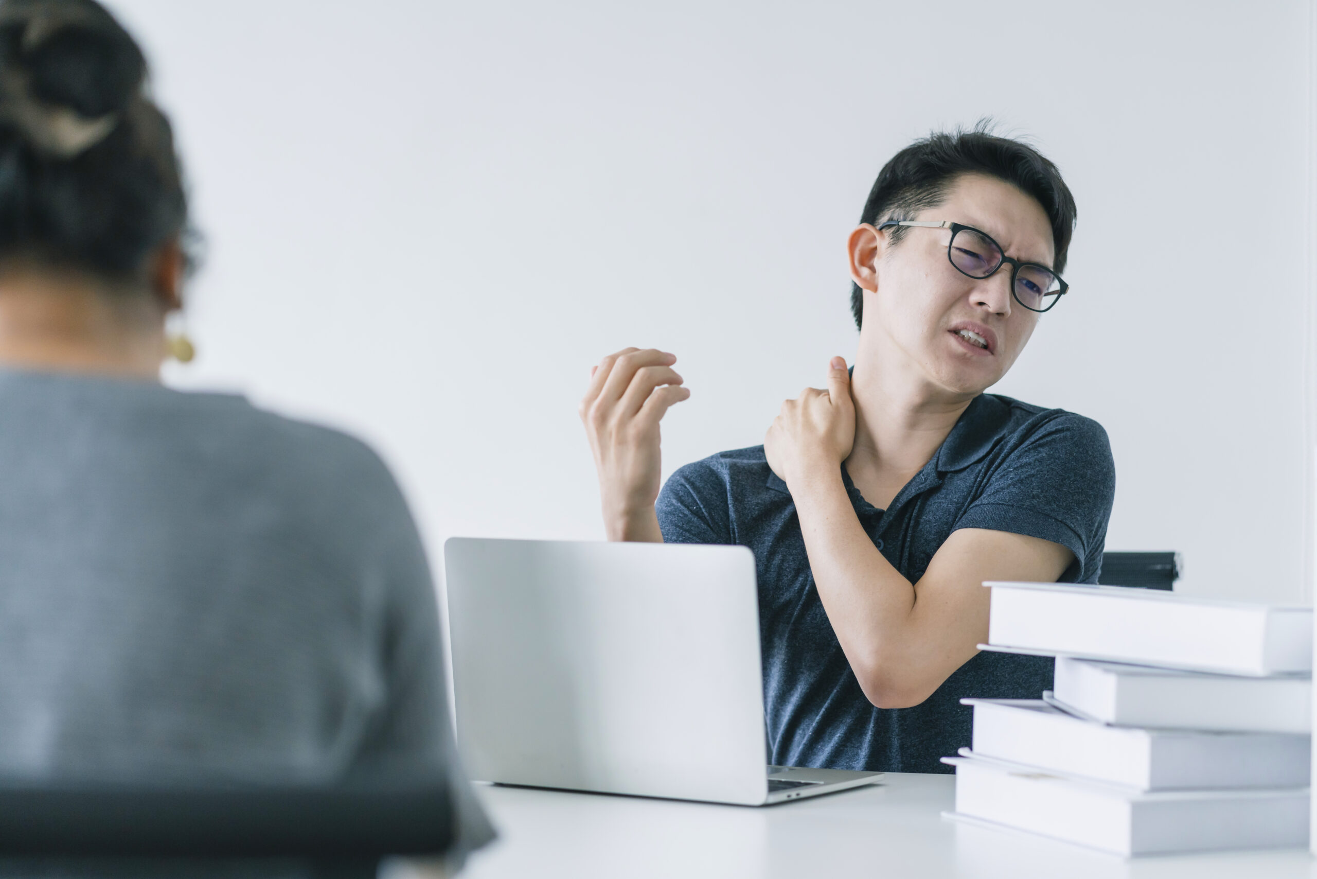 Asian working hard man with office syndrome have problem with pa office work injury