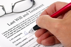 A hand holding a pen signs a “Last Will and Testament” document, with a pair of eyeglasses resting nearby—highlighting the importance of considering any potential family provision claim. A hand holding a pen signs a "Last Will and Testament" document, with a pair of eyeglasses resting nearby—highlighting the importance of considering any potential family provision claim.