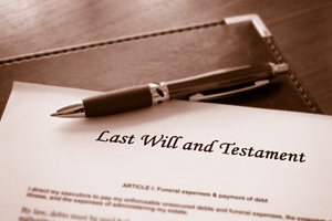 A pen rests on top of a document titled "Last Will and Testament," possibly outlining an Informal Will, with a leather folder partially visible underneath. The image is in sepia tones.