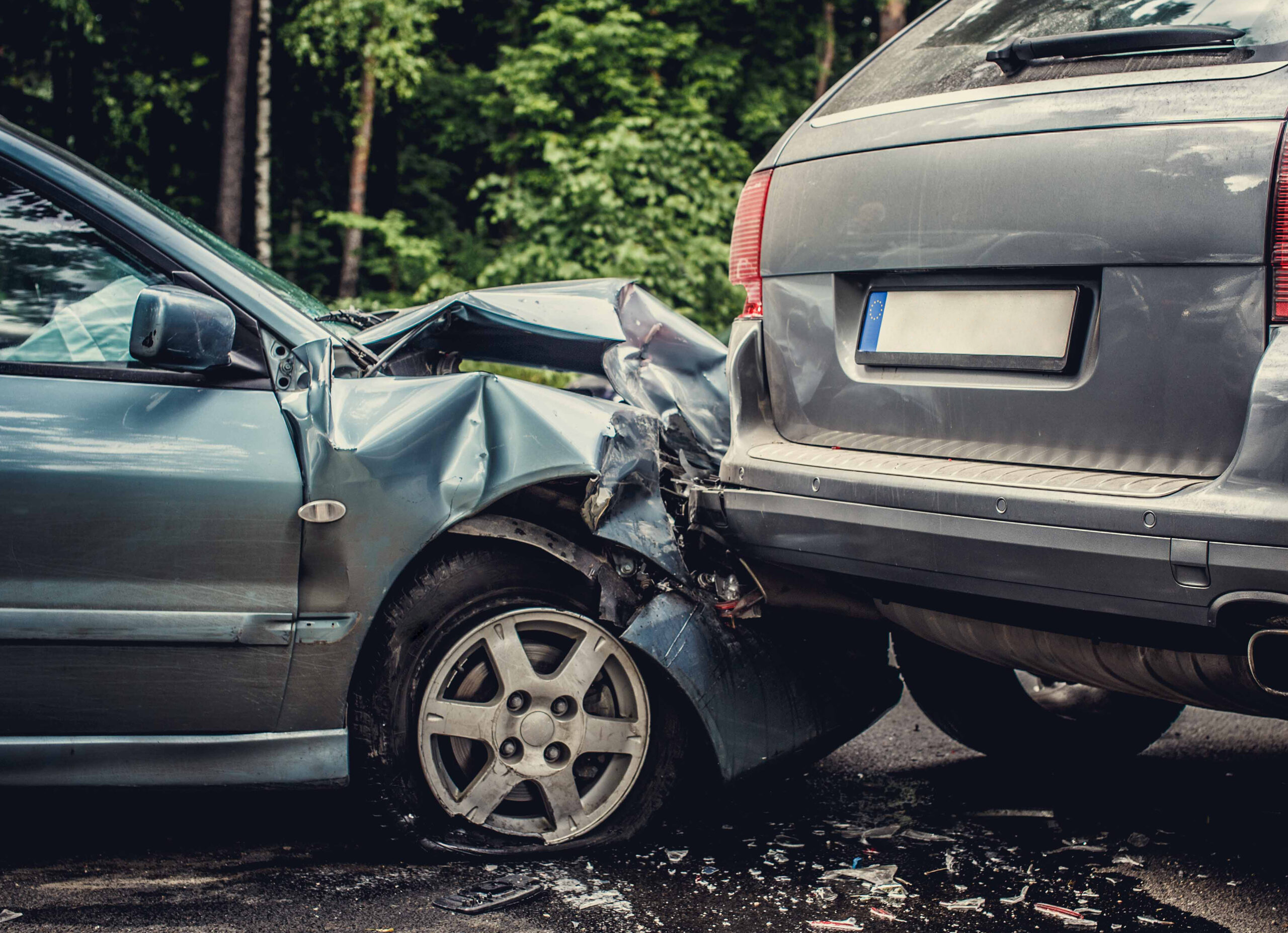 Close up smached cars on a road. Image of a auto accident involving two cars