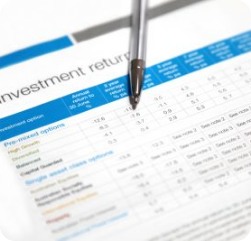 A close-up of a financial document titled “investment return,” displaying a table with various investment options and returns, with a pen resting on top of the paper. A close-up of a financial document titled "investment return," displaying a table with various investment options and returns, with a pen resting on top of the paper.