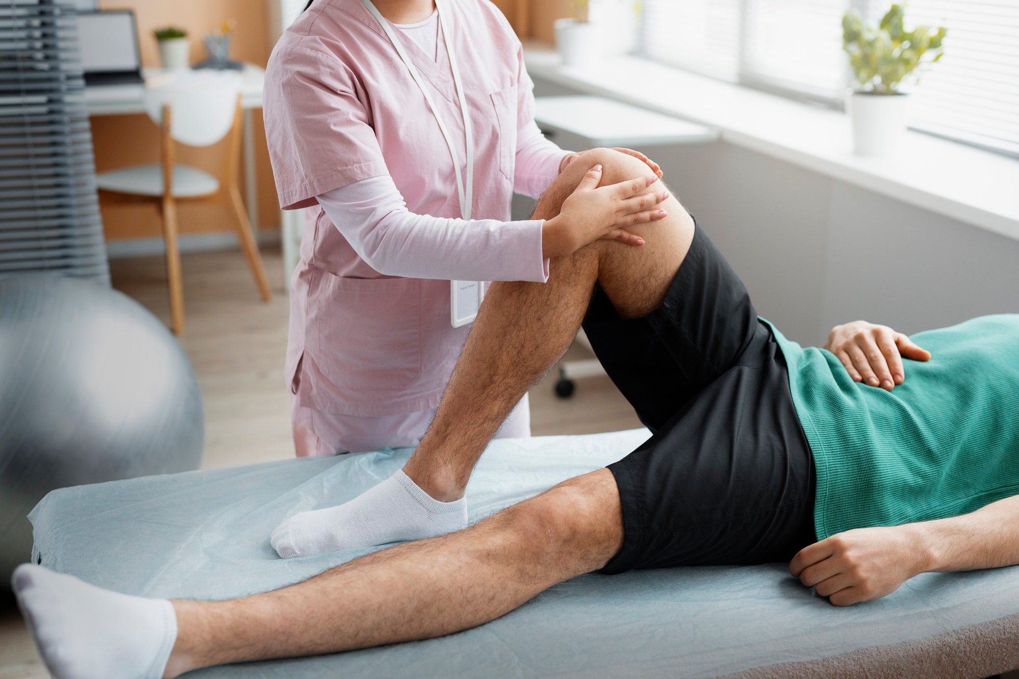Doctor helping patient during rehabilitation