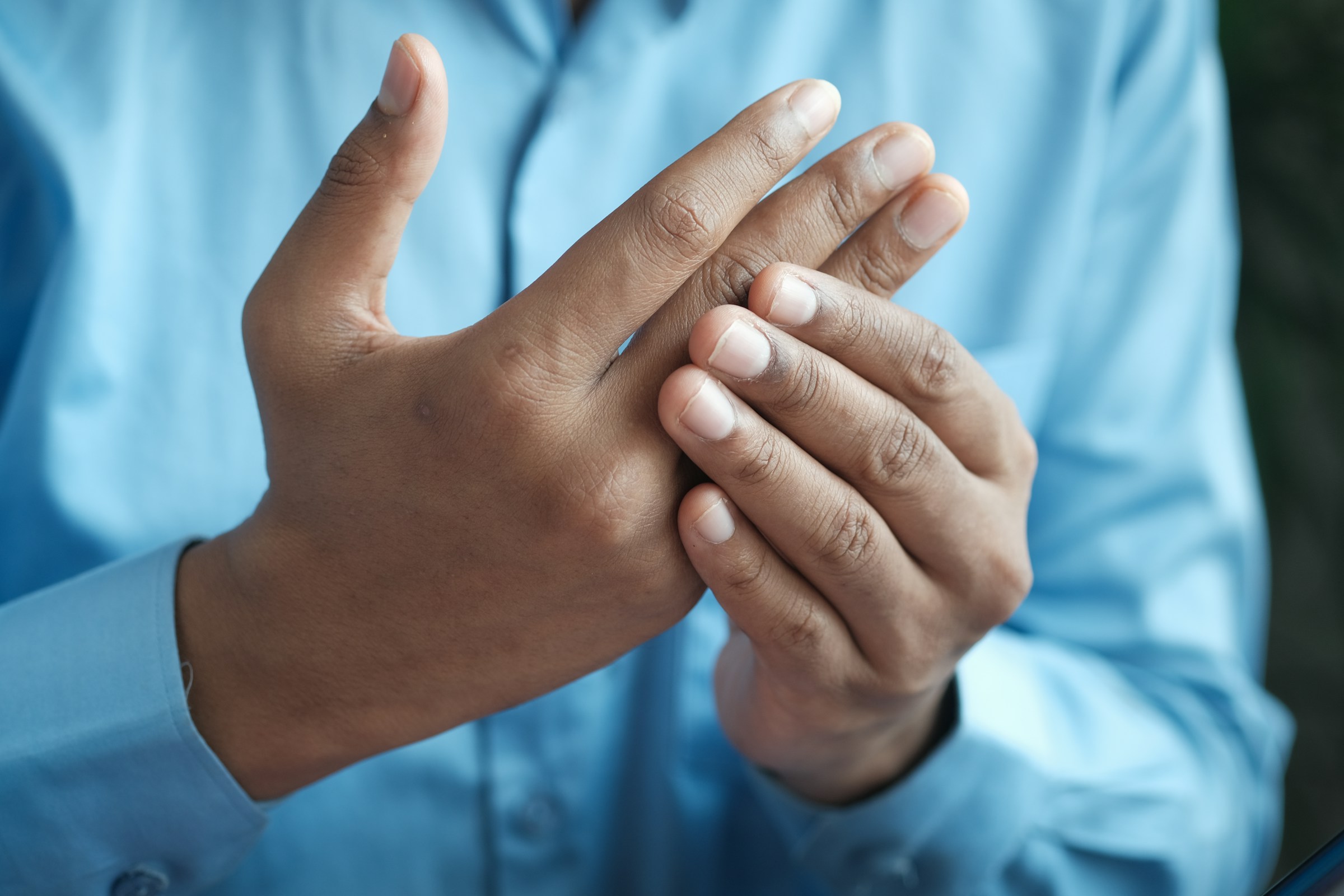 person in blue shirt showing left hand person in blue shirt showing left hand