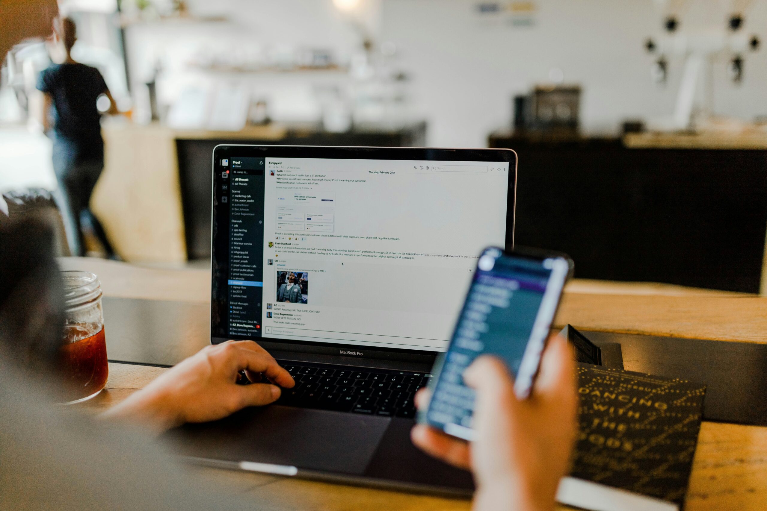 austin-distel-gUIJ0YszPig-unsplash person using phone and laptop